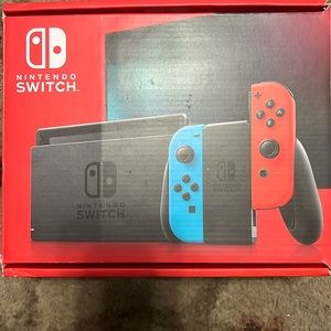 Nintendo Switch in box with an extra remote